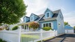 © Saka - A beautiful blue house with a white picket fence and lush greenery