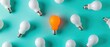 © GoStudio - Creative idea concept showing one glowing light bulb standing out among others, symbolizing innovation, uniqueness, inspiration and fresh thinking for business and creativity.