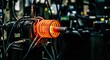 © matkhairul - Intense glowing industrial coil heating metal rod within manufacturing equipment