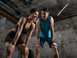 © master1305 - Man and woman resting after workout smiling during gym training session. Concept of healthy lifestyle, fitness motivation, positive experience and gym membership retention