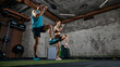 © master1305 - Man and woman performing high knee exercise during functional training in gym. Concept of cardio workout, fitness program routine, endurance training and active lifestyle
