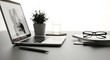 © Aabirah Graphics - Minimalist workspace setup with laptop plant and glasses for a productive environment