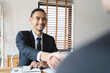 © Pormezz - hand of client and banker shaking hands  on the meeting table after business investment budget done