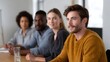 © Bussakon - Diverse professionals engaged in a focused business discussion within a modern collaborative office setting