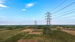 © VisualTreat12 - High voltage transmission towers across rural landscape with power lines aerial view