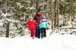 © ADDICTIVE STOCK - Family enjoying a snowy winter walk in the forest