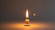 © Igor - Candle burning softly with flickering flame on dark background