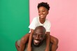 © Andrii Zastrozhnov - Father giving daughter piggyback ride in studio with panels