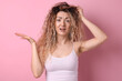 © New Africa - Unhappy woman with tangled hair on pink background