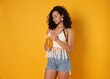 © New Africa - Woman with cocktail wearing beachwear on orange background