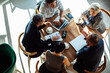 © Marko Geber - Top view of business team meeting in cafe