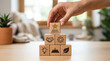 © alex - Hand building a strategic brand identity with wooden blocks, representing key business concepts for growth and market success
