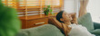 © Monster Ztudio - Relaxed young Asian woman enjoying rest on comfortable sofa, calm attractive girl relaxing on couch, breathing fresh air with eyes closed, meditating at home
