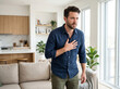 © Meow Creations - Man experiencing shortness of breath with hand on chest at home