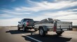© Angavlan - Truck towing trailer on highway with clear skies above and motion blur showing speed. Truck towing small trailer moves down the road, showcasing utility and adventure.