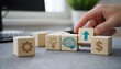 © Pixzens Ars - Hand placing wooden block with blue upward arrow on desk with other blocks
