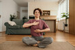 © La Famiglia - Woman practicing deep breathing exercise for mindfulness at home