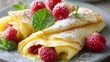 © fivan - Lemon curd crepes folded delicately and dusted with powdered sugar, served with raspberries and mint leaves in bright spring light
