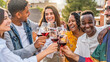 © Davide Angelini - Young people toasting red wine glasses at farm house vineyard countryside