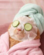 © Dat - Cute ginger cat enjoying a self-care spa day with a sheet mask in a pink bathroom.