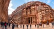 © dewi - Tourists exploring ancient Petra Treasury in Jordan under bright daylight