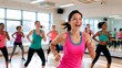 © Przemek - Joyful group of diverse women participating in an energetic cardio aerobics workout class in a bright, sunlit modern fitness studio