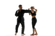 © Lustre Art Group  - Man demonstrating defensive hand block while woman practices attack during training. Concept of technique learning, reaction training, coordination skills and safe combat practice environment.