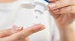 © Iryna - Caucasian young woman applying solution to contact lens on finger, eye care and hygiene in precision handling