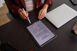 © David - Businesswoman digitally signing contract on tablet with stylus