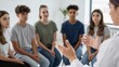 © Studicon - Teenagers listen to a healthcare provider during a group therapy session indoors