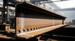 © Lucianastudio - Heavy industrial steel I-beam with rivets showing signs of rust and wear, representing construction and manufacturing processes in a factory setting.