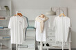 © Pixel-Shot - Mannequin and racks with t-shirts in dressing room