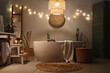 © Pixel-Shot - Interior of bathroom with glowing lights, burning candles and bathtub in evening
