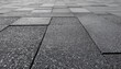 © Eclat by Lissa - Close-up perspective of dark grey asphalt shingles, showcasing the granular texture and geometric pattern of a modern roof surface, ideal for construction and architectural design backgrounds