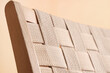 © Pixel-Shot - Texture of wicker armchair near yellow wall in living room, closeup