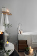 © Pixel-Shot - Bathtub and burning candles near grey wall in interior of bathroom