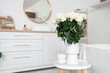© Pixel-Shot - Vase with white roses on table in bathroom