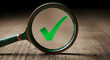 © Microstock - Magnifying glass focusing on a green checkmark, symbolizing confirmation, accuracy, and a successful outcome