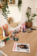 © Pixel-Shot - Different makeup products with plant on table in light dressing room