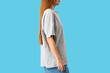 © Pixel-Shot - Young woman in stylish grey t-shirt on blue background