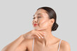 © Pixel-Shot - Young Asian woman with contouring on light background, closeup
