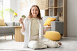 © Pixel-Shot - Happy young woman eating sushi in living room