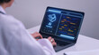 © Piya W. - Focused doctor works on laptop with advanced ai assistant interface displaying futuristic medical technology data for research and analysis