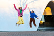 © Westend61 - Two friends jumping outdoors showing fun and excitement