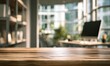 © rahmat - Empty wooden table surface, blurred modern office interior with computer in background