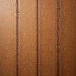 © Viktor - Seamless light brown leather texture with embossed stitch lines and circular patterns. This detailed material offers a warm, rich finish for various design applications and backgrounds.