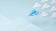 © Desmon - Leadership Concept Blue Paper Airplane Leading White Airplanes on Light Blue