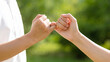 © hyo - Close Up of Two Hands Making a Pinky Swear in Nature