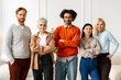 © Maria Vitkovska - Diverse business team standing together in office looking at camera