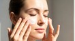 © sem.studio - Young woman applying moisturizer to her face, promoting healthy skin and self-care routines